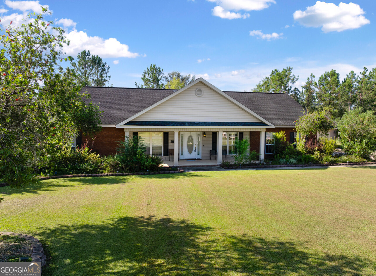 a front view of a house with swimming pool having outdoor seating