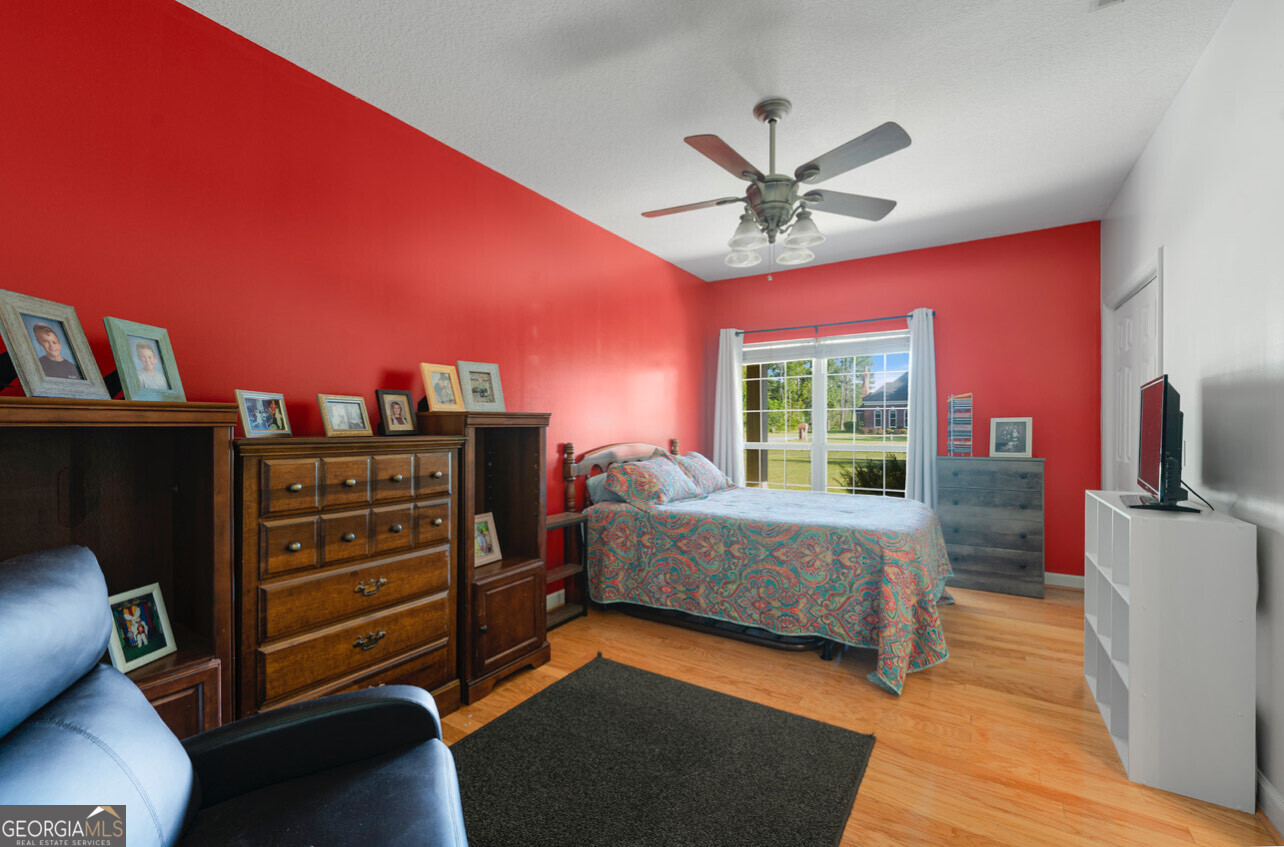 646 Corey Street Baxley, GA 31513 - Photo 16 of 21 a bedroom with a bed and wooden floor