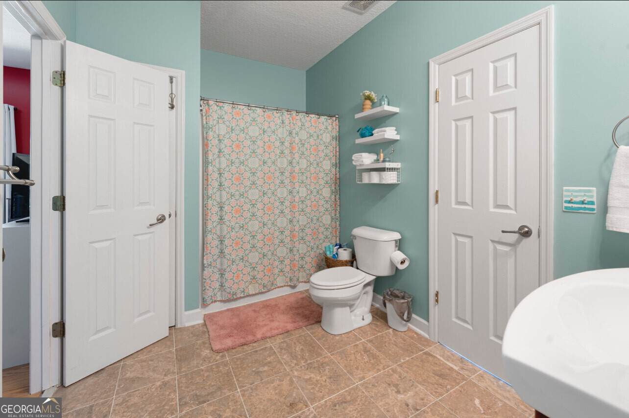 646 Corey Street Baxley, GA 31513 - Photo 17 of 21 a bathroom with a toilet sink and shower