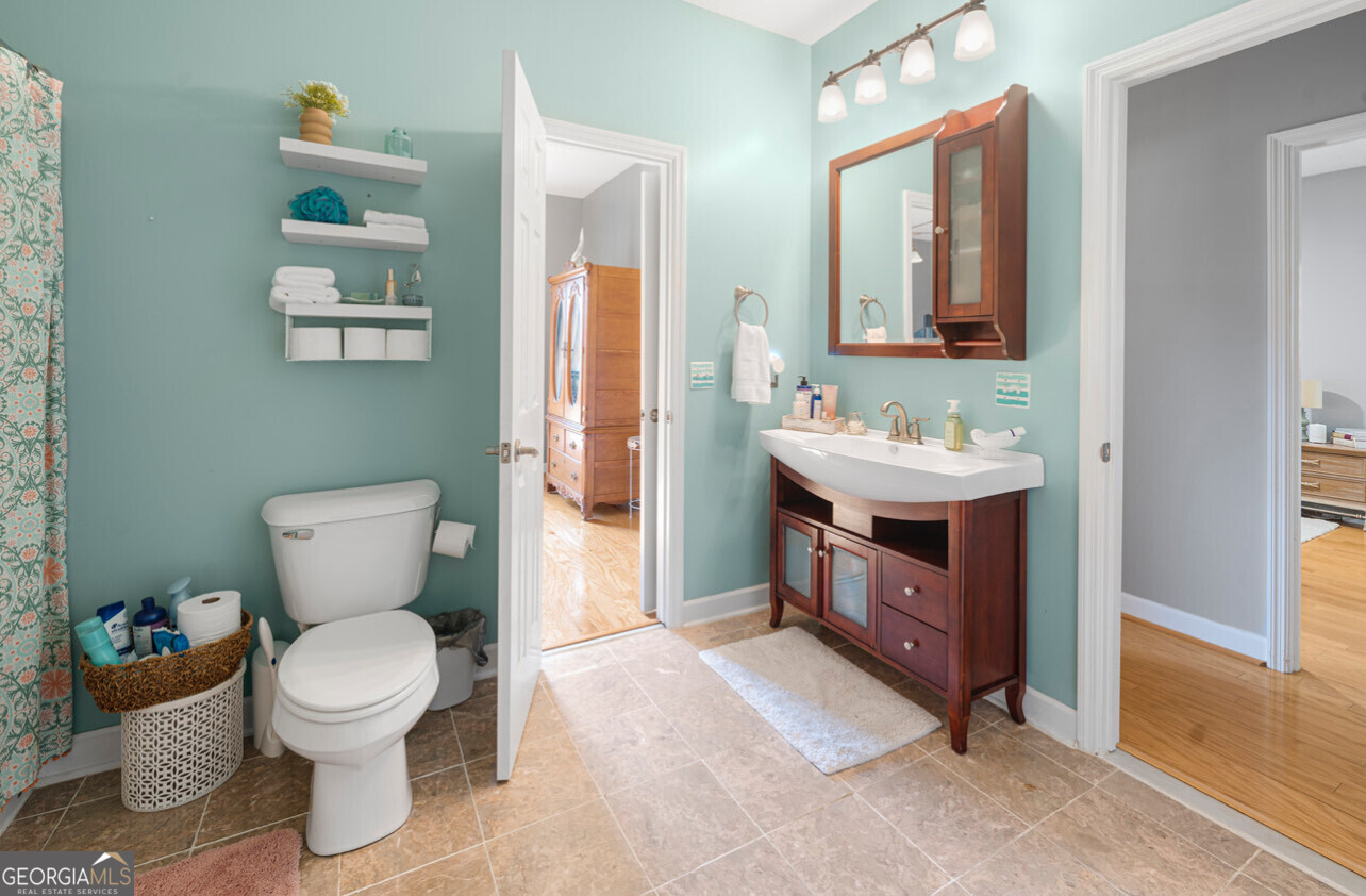 646 Corey Street Baxley, GA 31513 - Photo 19 of 21 a bathroom with a toilet a sink and mirror