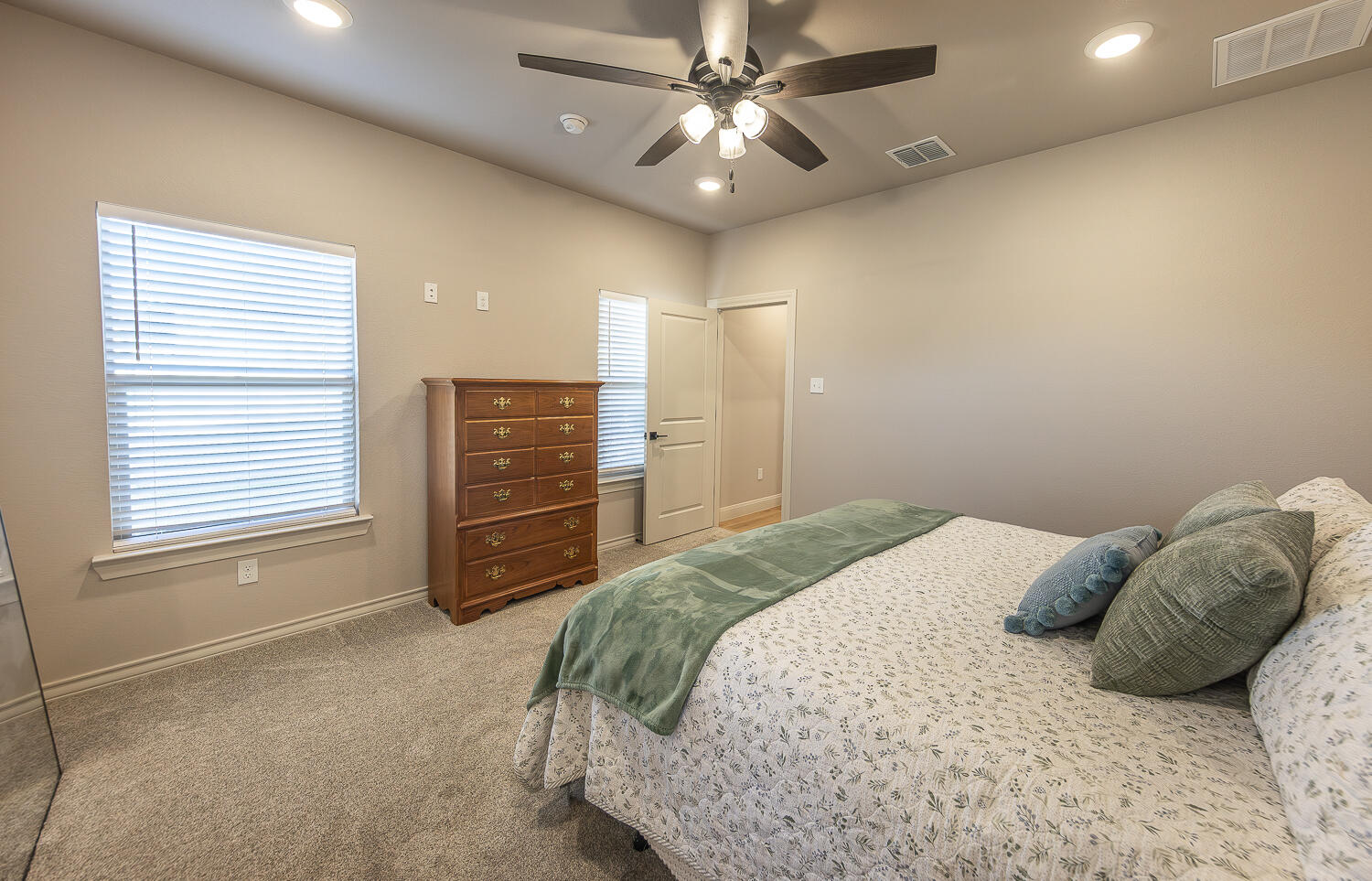 6913 15th Street Lubbock, TX 79416 - Photo 12 of 27 a bedroom with a bed and a ceiling fan