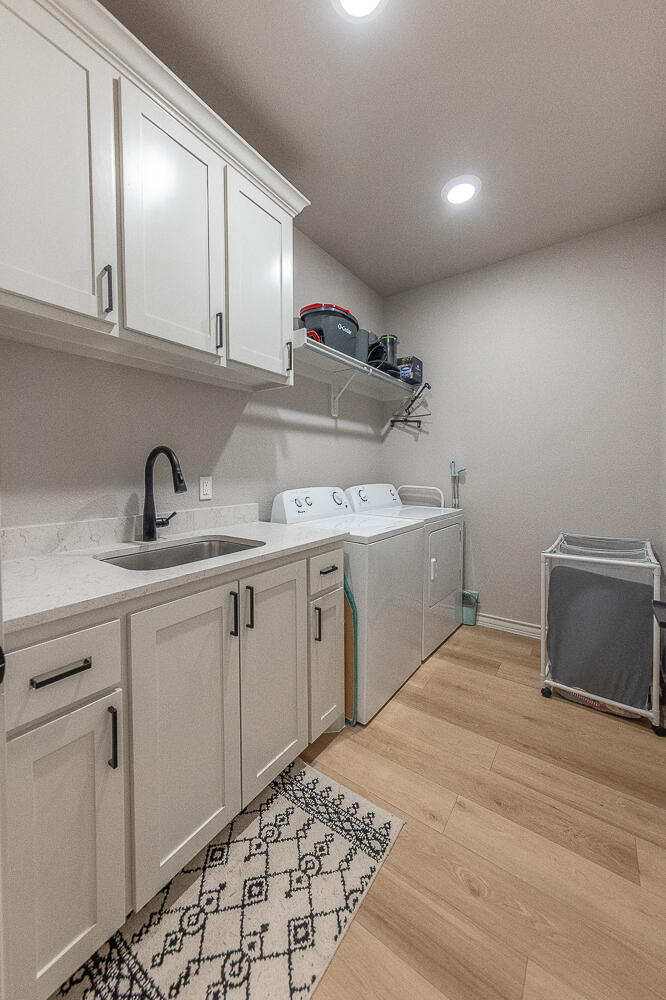 6913 15th Street Lubbock, TX 79416 - Photo 15 of 27 a kitchen with a sink and cabinets