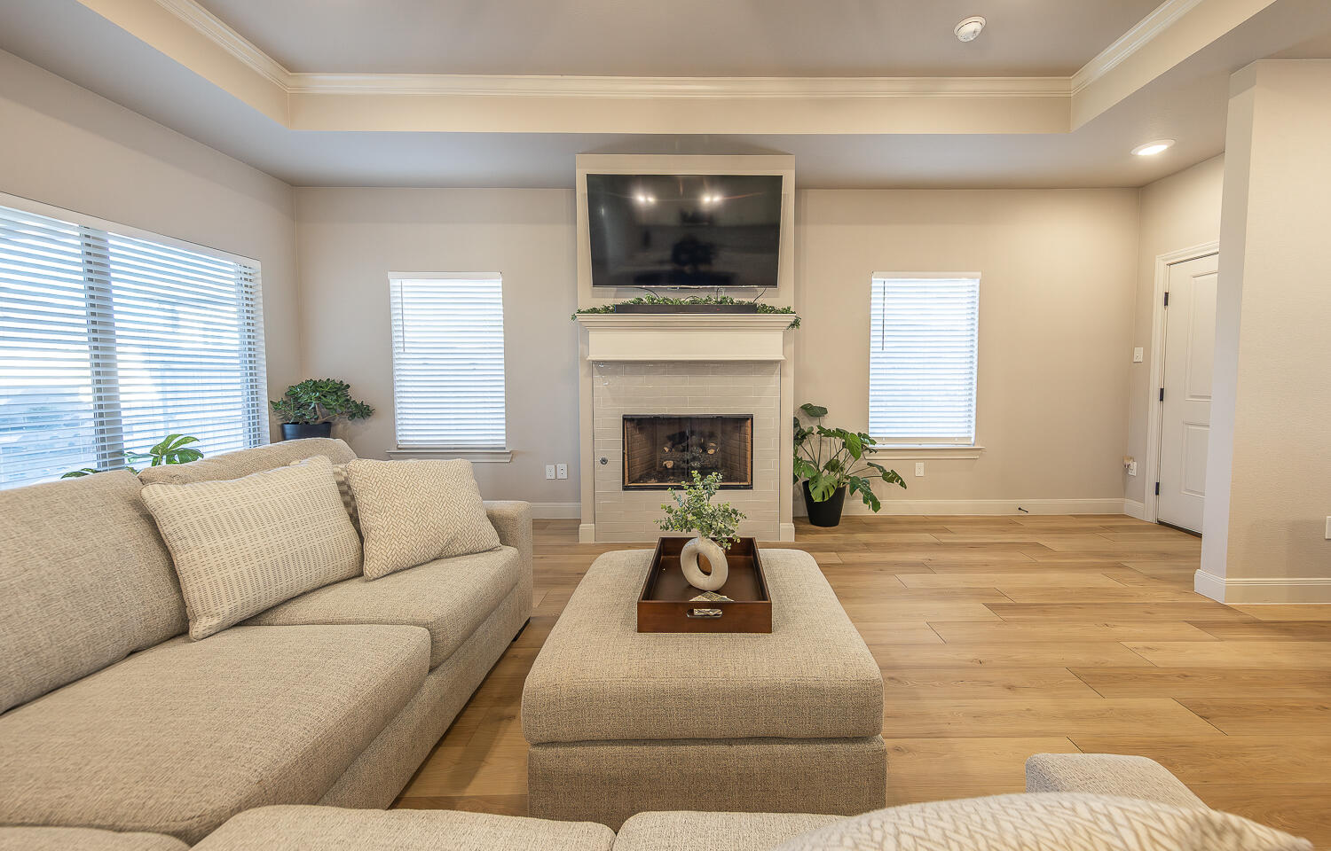 6913 15th Street Lubbock, TX 79416 - Photo 2 of 27 a living room with furniture a fireplace and a flat screen tv