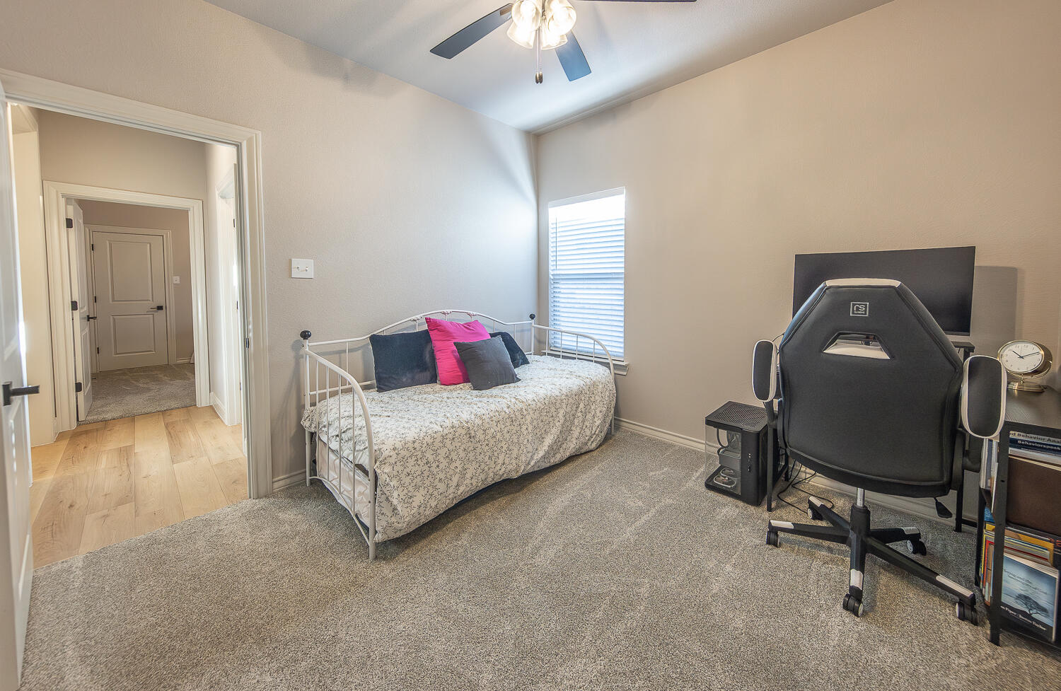 6913 15th Street Lubbock, TX 79416 - Photo 21 of 27 a bedroom with a bed and a chandelier