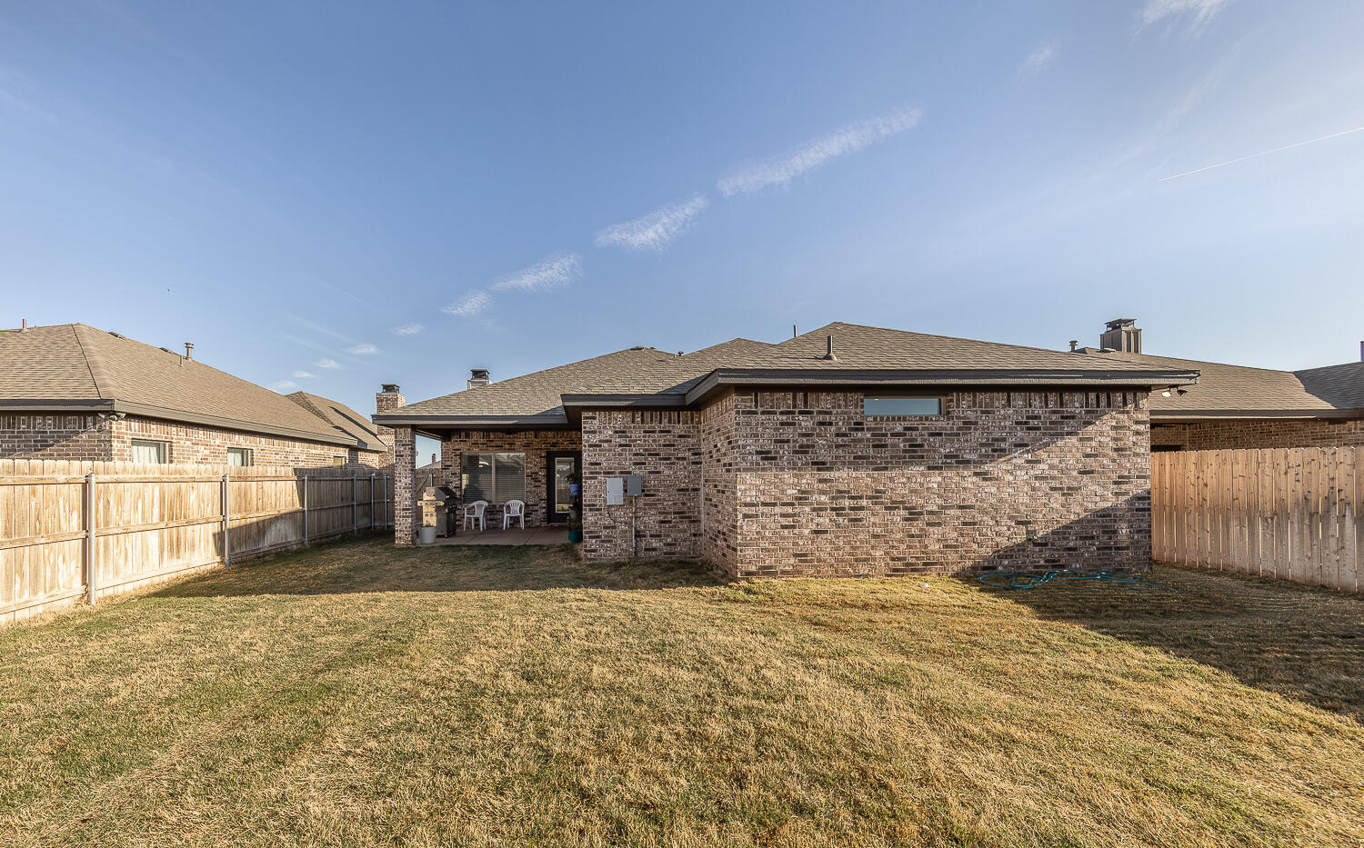 6913 15th Street Lubbock, TX 79416 - Photo 25 of 27 a front view of a house with a yard and garage