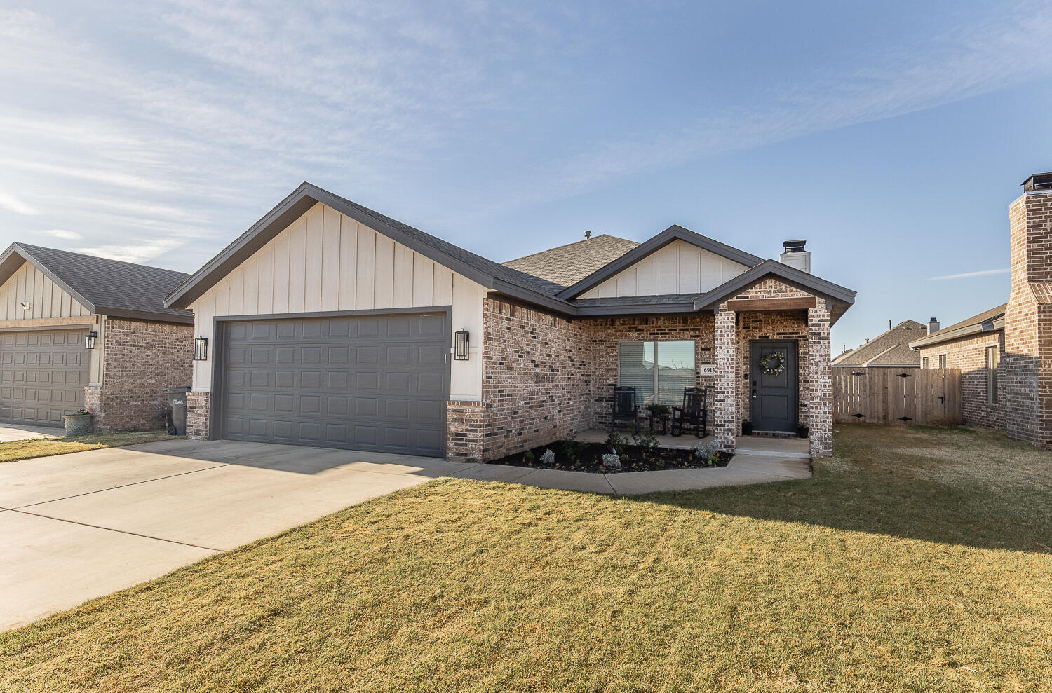 6913 15th Street Lubbock, TX 79416 - Photo 26 of 27 a front view of a house with a yard