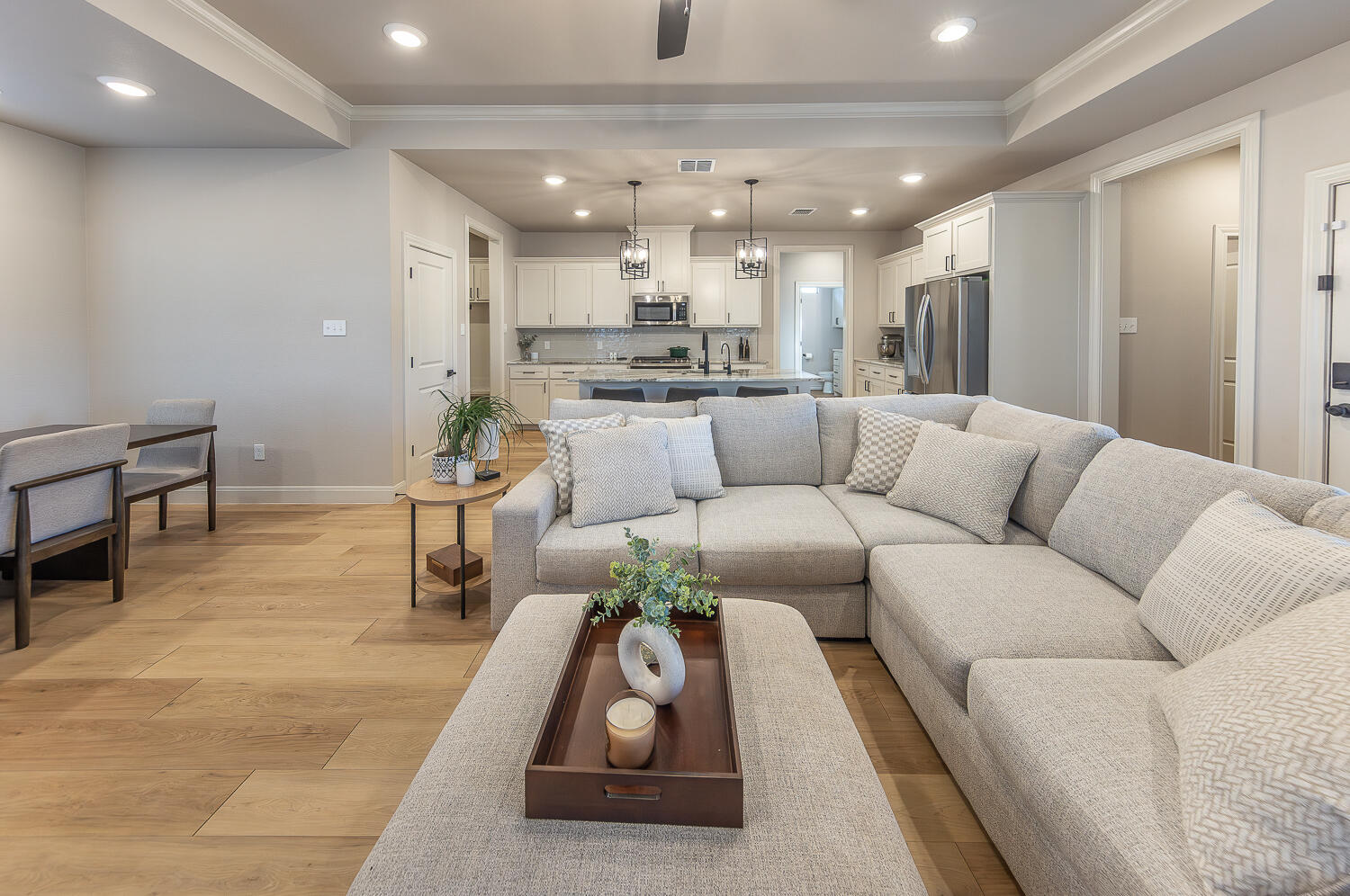 6913 15th Street Lubbock, TX 79416 - Photo 6 of 27 a living room with furniture and a dining table with kitchen view