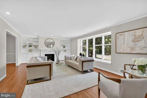 a living room with furniture a fireplace and a window
