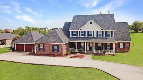 a aerial view of a house with a yard and potted plants