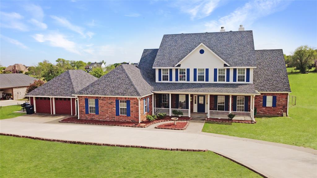 a aerial view of a house with a yard and potted plants