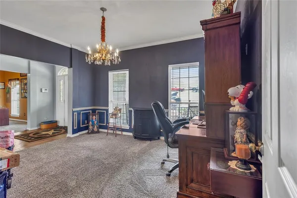 a view of a livingroom with workspace and a window