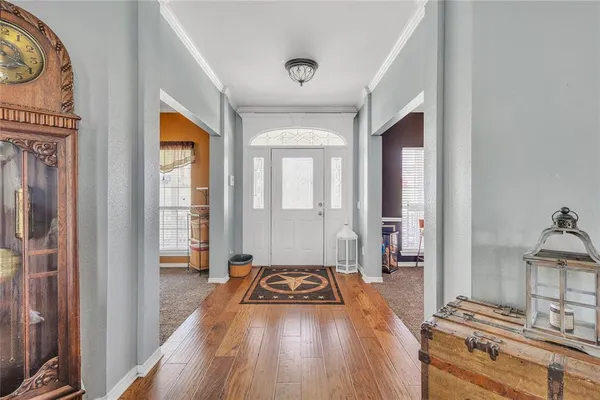 a view of a bedroom with wooden floor