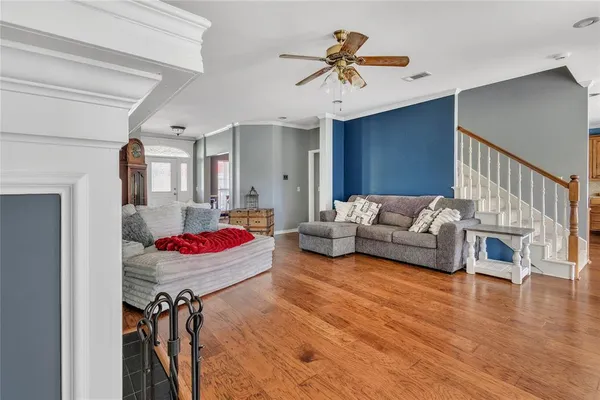 a living room with furniture and kitchen view
