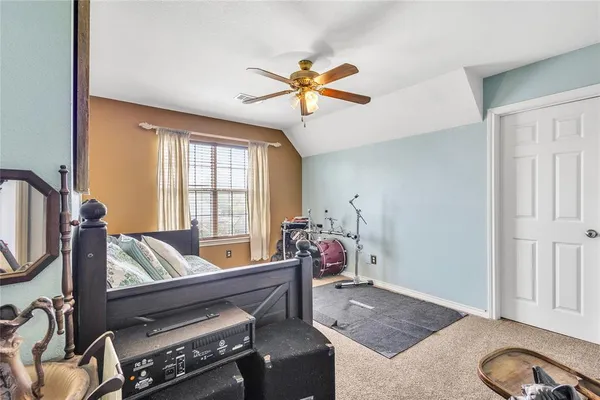 a living room with furniture a flat screen tv and a window