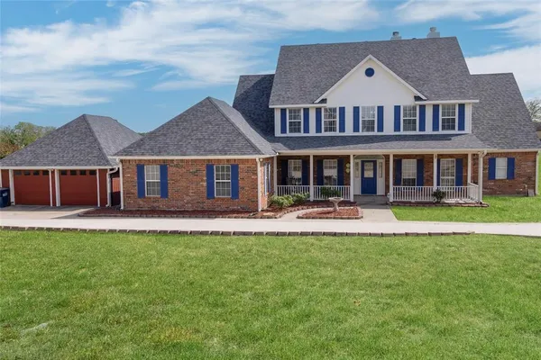 a front view of a house with swimming pool and porch