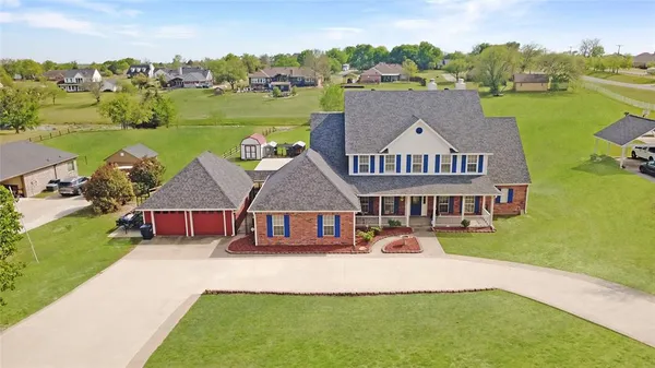 an aerial view of a house with swimming pool garden and patio