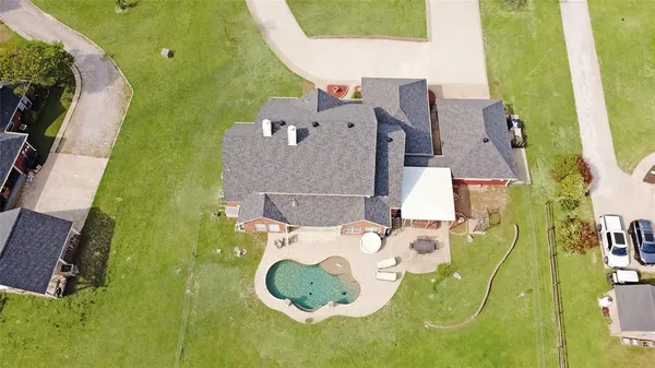 an aerial view of a house with a swimming pool