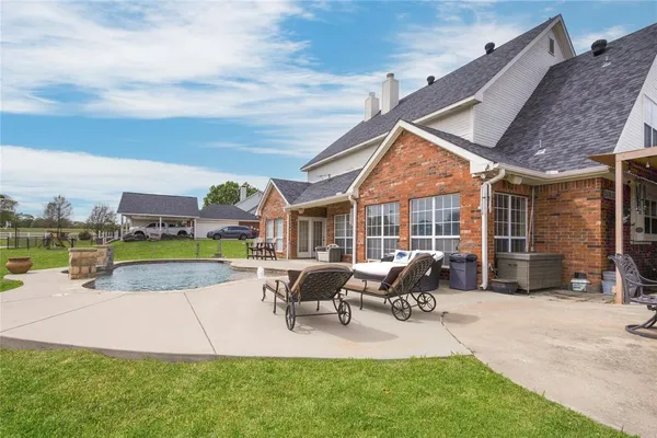 a view of a house with backyard porch and sitting area