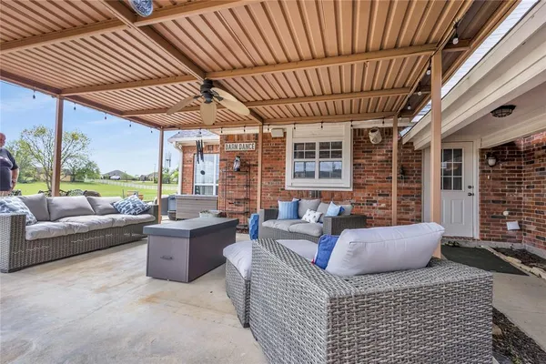 a outdoor living space with patio furniture and garden view