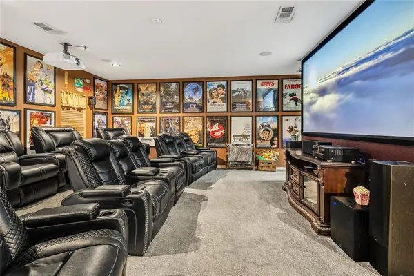 a living room with furniture a flat screen tv and a floor to ceiling window