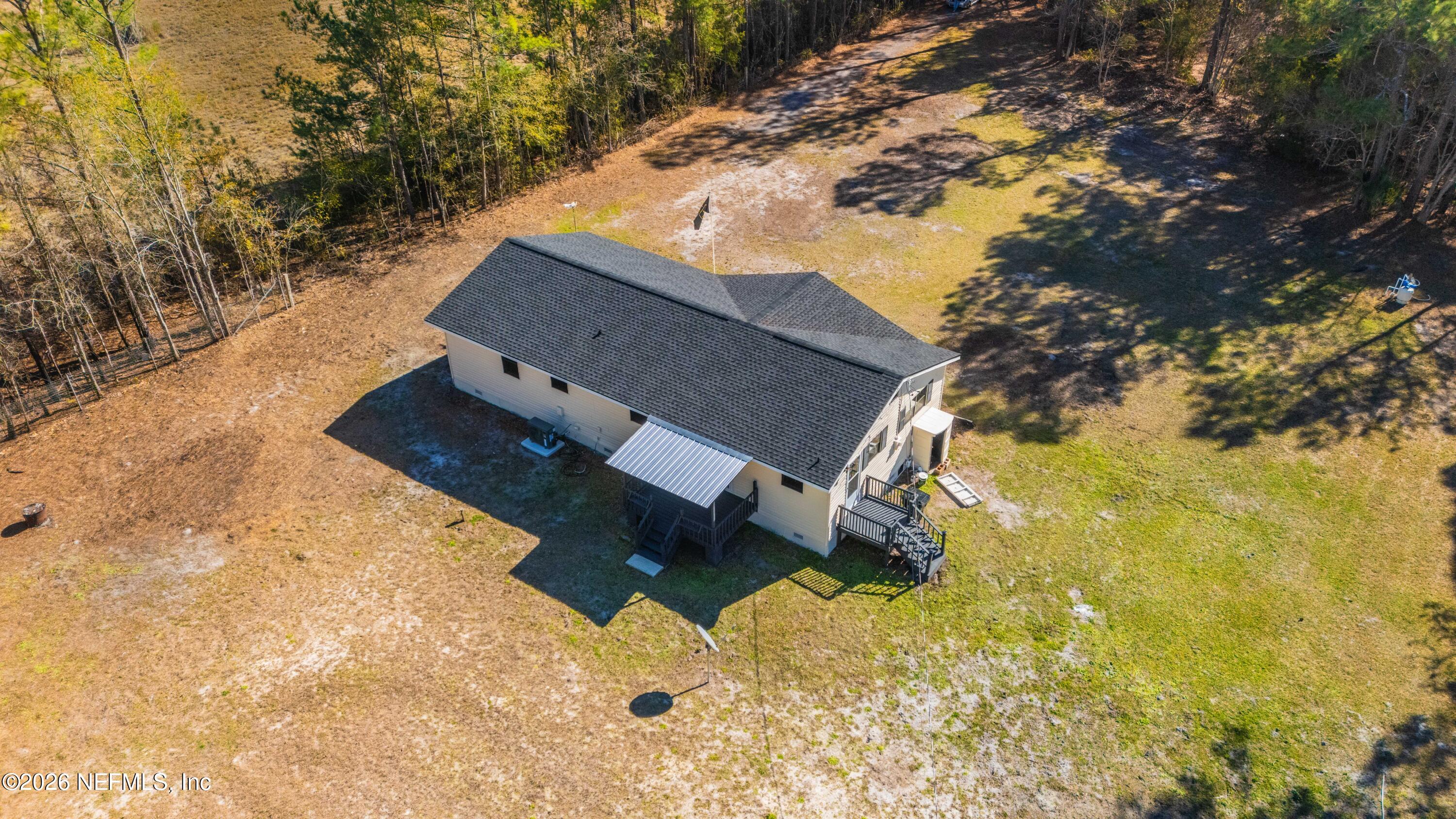 6346 Memory Lane Jacksonville, FL 32234 - Photo 2 of 31 a backyard of a house with large trees