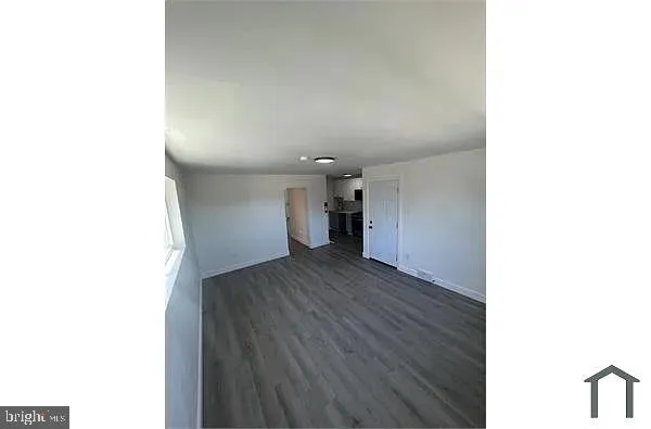 a view of a room with wooden floor