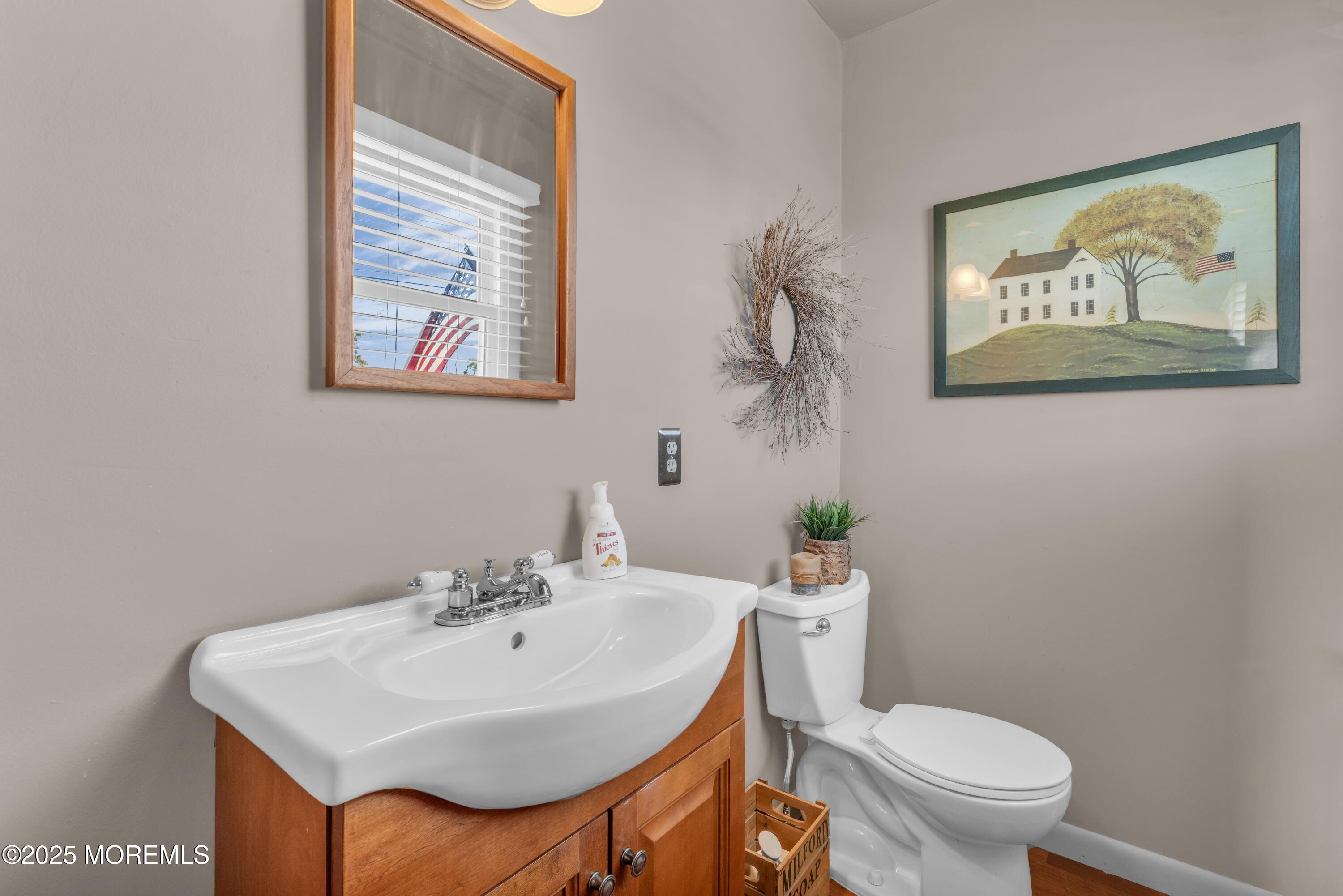 181 Mast Road Brick, NJ 08723 - Photo 16 of 24 a bathroom with a toilet a sink and mirror