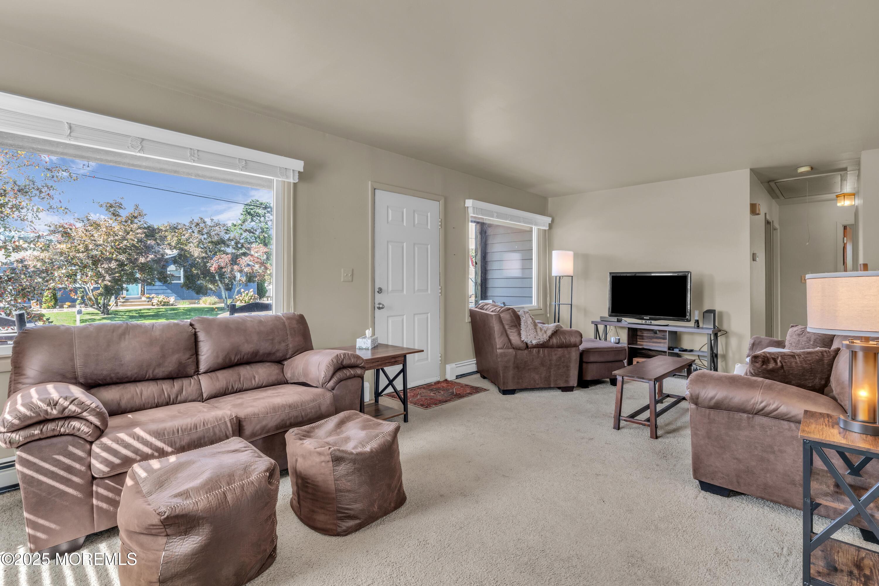 181 Mast Road Brick, NJ 08723 - Photo 4 of 24 a living room with furniture and a flat screen tv