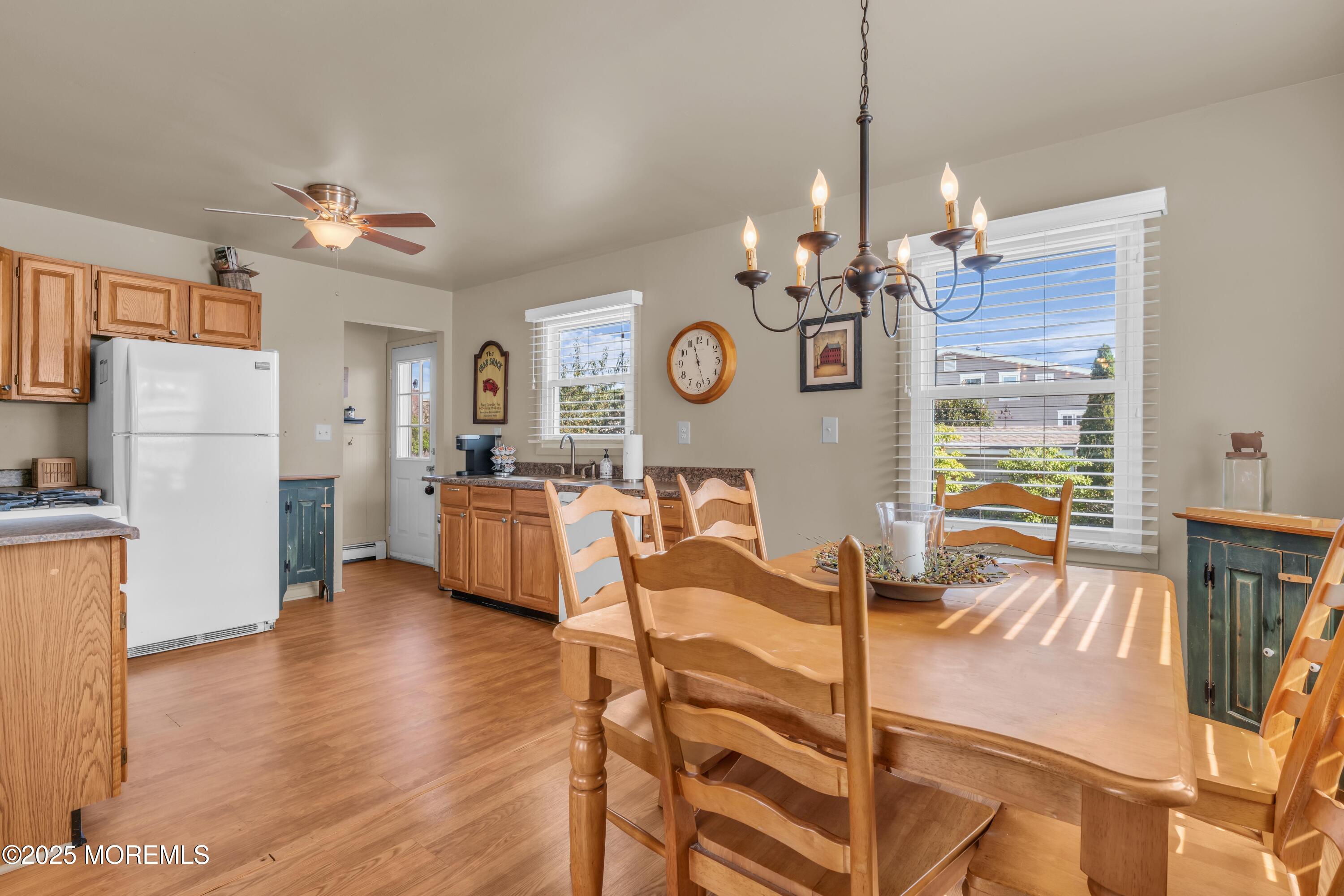 181 Mast Road Brick, NJ 08723 - Photo 8 of 24 a view of a dining room with furniture a chandelier and wooden floor