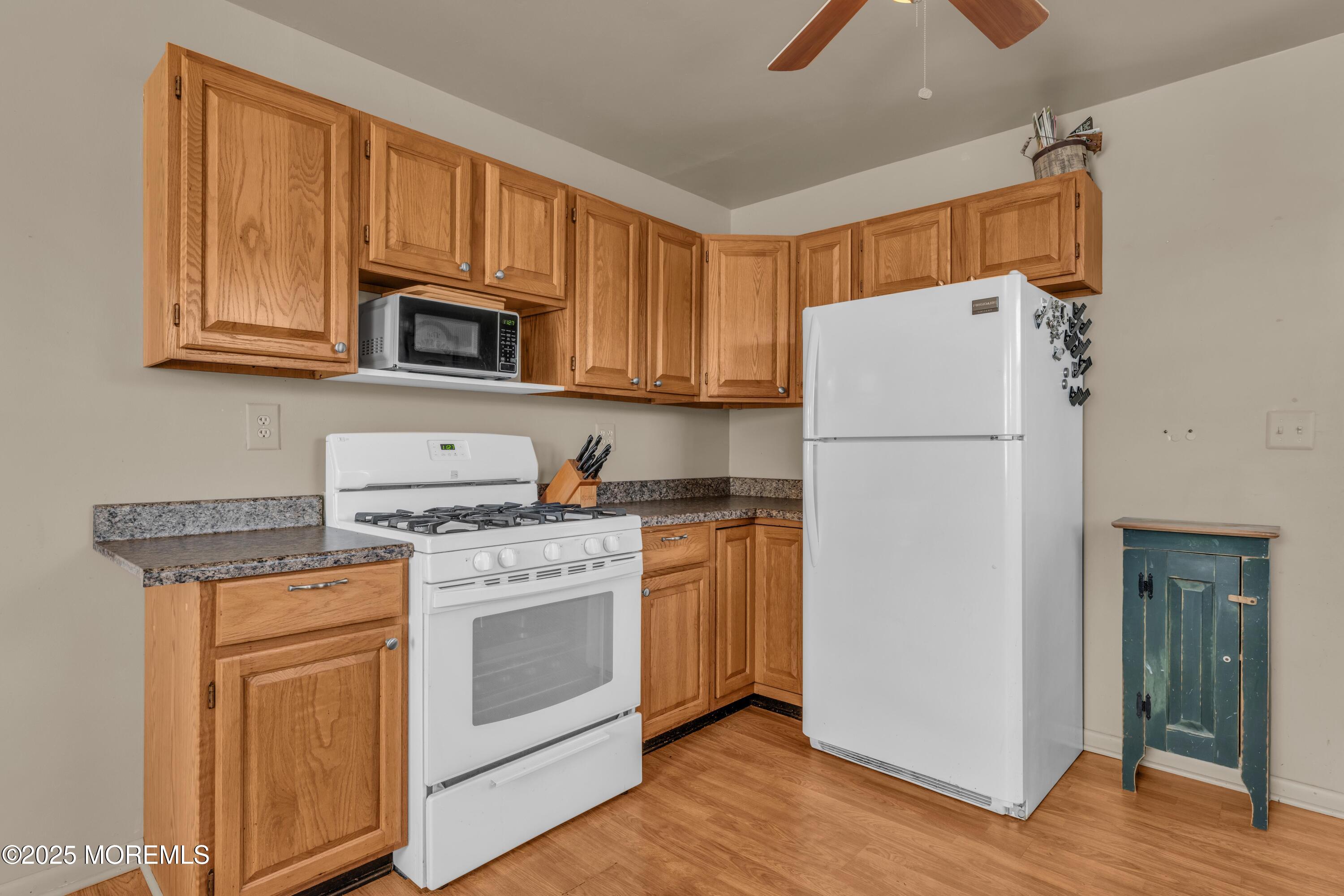 181 Mast Road Brick, NJ 08723 - Photo 10 of 24 a kitchen with a stove a refrigerator and a sink
