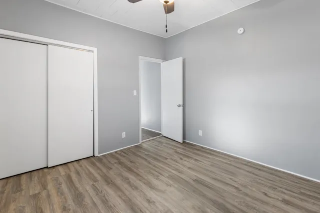 a view of an empty room with wooden floor