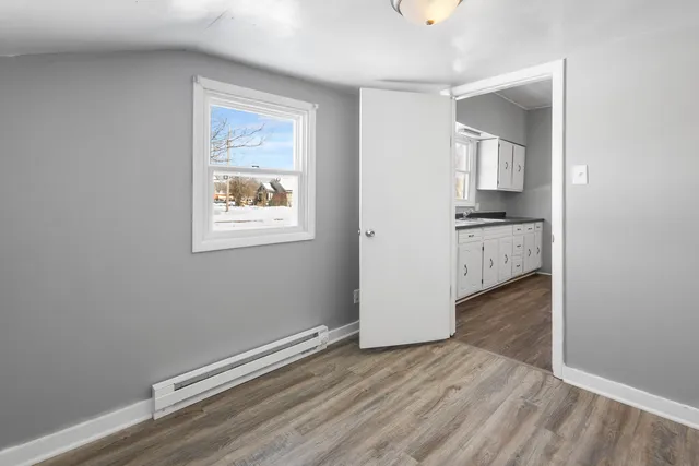 wooden floor in an empty room with a window