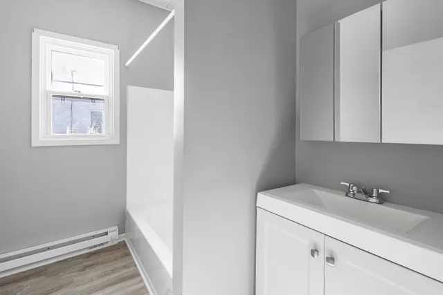 a bathroom with a sink and a window