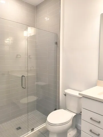 a white toilet sitting next to a bathroom sink