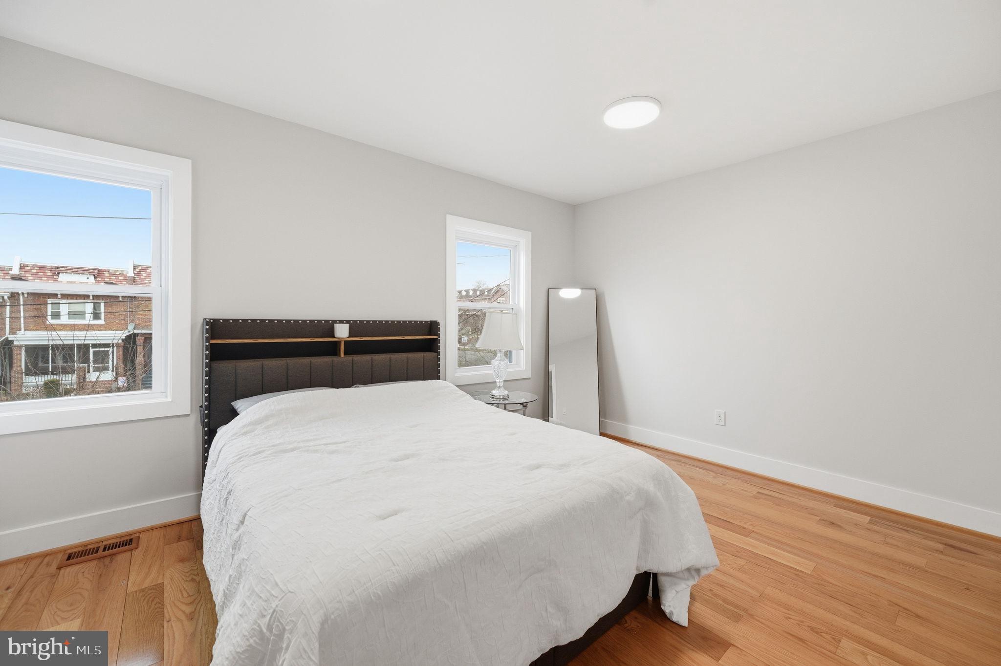4902 4th Street Northwest Washington, DC 20011 - Photo 11 of 24 a bedroom with a bed and wooden floor