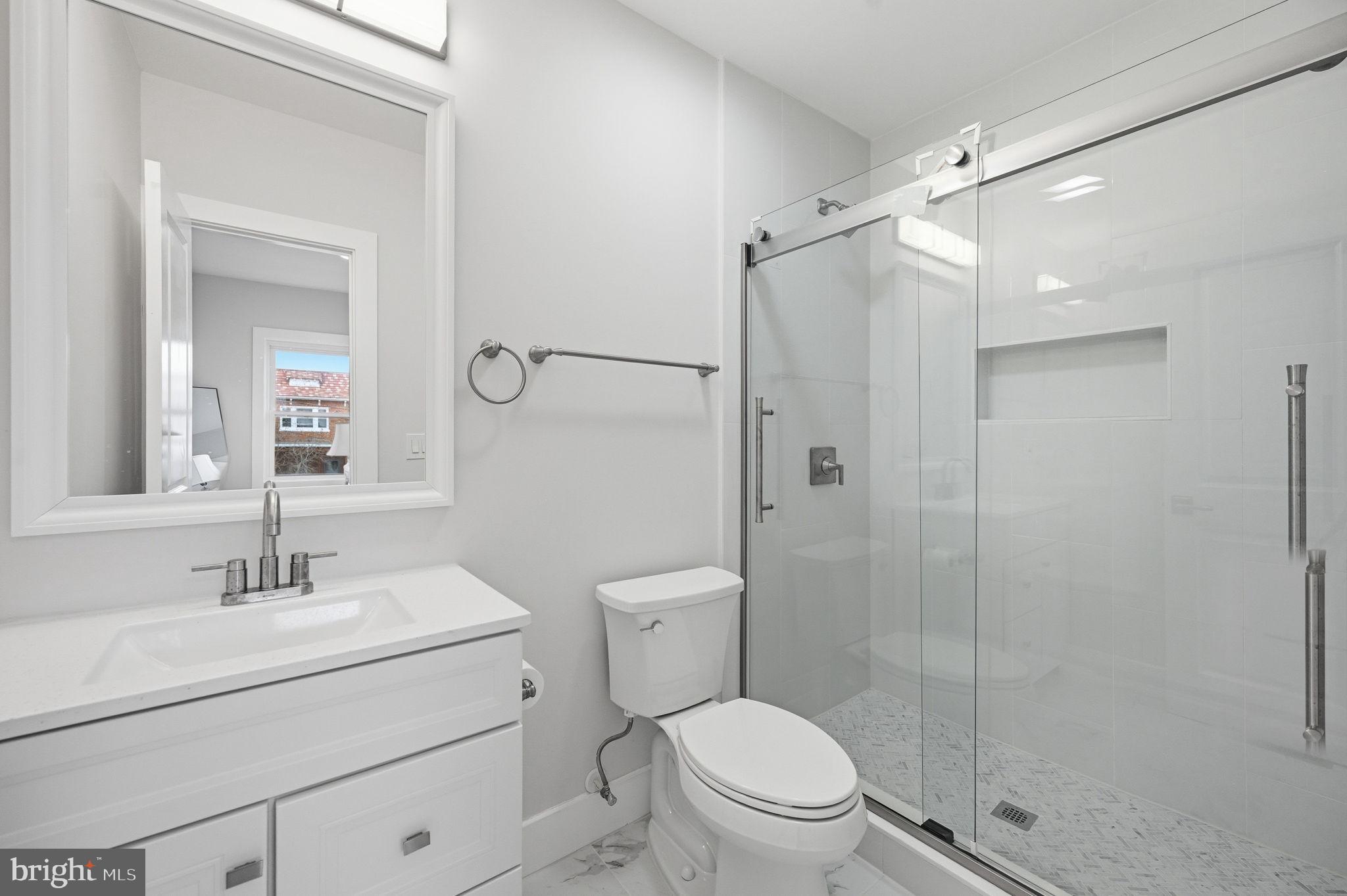 4902 4th Street Northwest Washington, DC 20011 - Photo 12 of 24 a bathroom with a shower sink vanity mirror and toilet