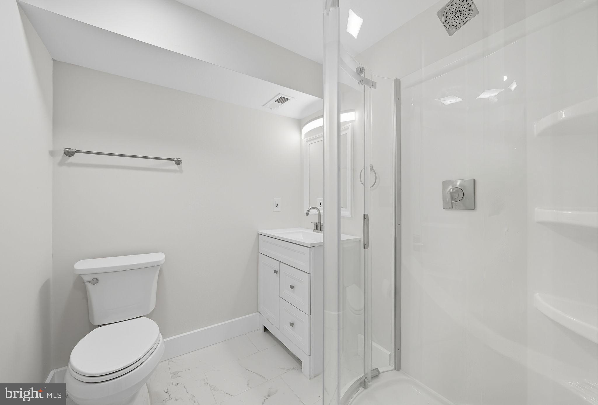 4902 4th Street Northwest Washington, DC 20011 - Photo 18 of 24 a bathroom with a toilet a sink a mirror and vanity