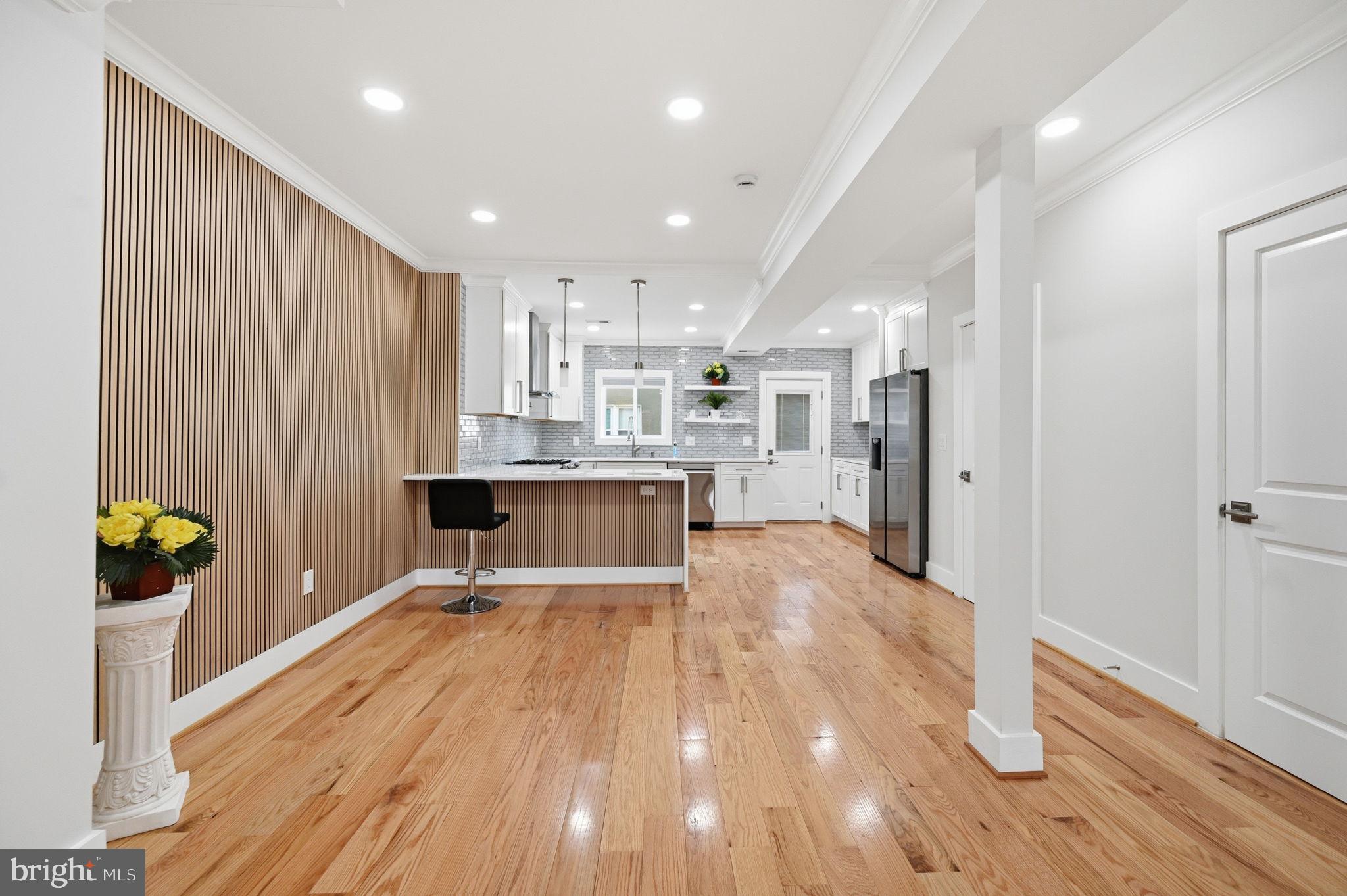 4902 4th Street Northwest Washington, DC 20011 - Photo 5 of 24 a living room with stainless steel appliances furniture refrigerator and wooden floor
