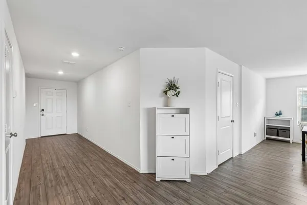 a view of an empty room and wooden floor