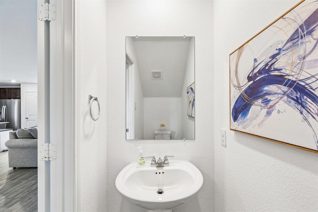 3044 Harper Street Little Elm, TX 75068 - Photo 13 of 24 a bathroom with a sink and a mirror