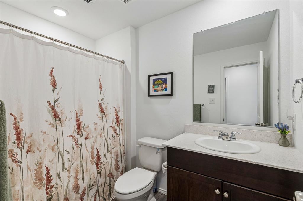 3044 Harper Street Little Elm, TX 75068 - Photo 15 of 24 a bathroom with a sink and a mirror