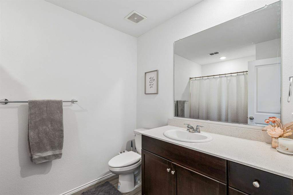 3044 Harper Street Little Elm, TX 75068 - Photo 18 of 24 a bathroom with a sink toilet and shower