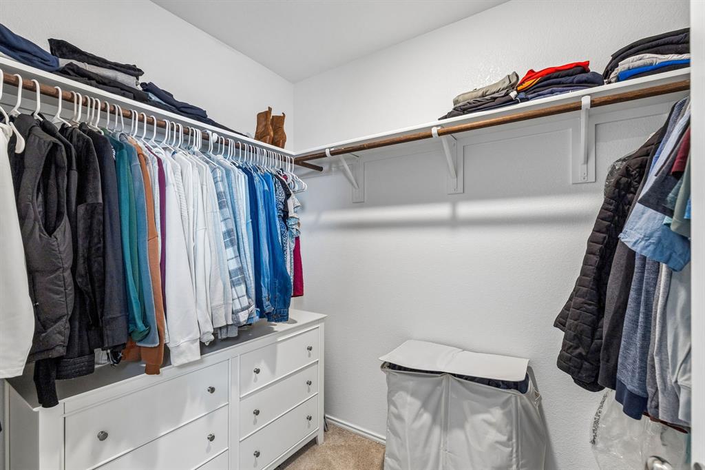 3044 Harper Street Little Elm, TX 75068 - Photo 19 of 24 a view of walk in closet with clothes and shoes