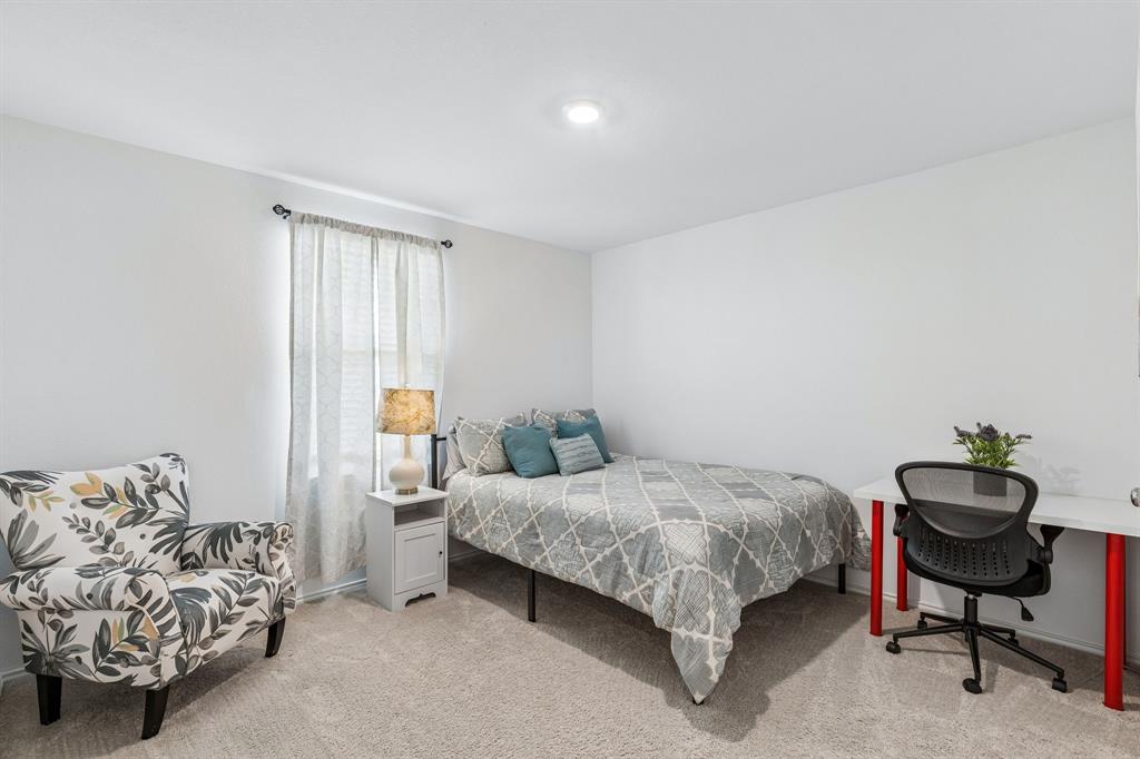 3044 Harper Street Little Elm, TX 75068 - Photo 21 of 24 a bedroom with a bed and a window