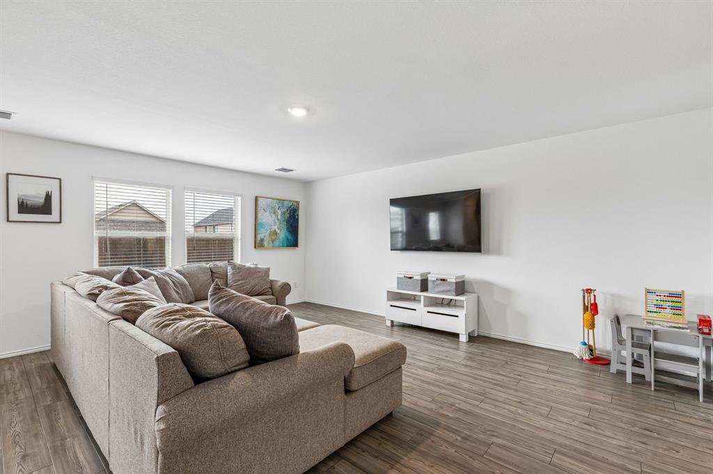 3044 Harper Street Little Elm, TX 75068 - Photo 4 of 24 a living room with furniture and a flat screen tv