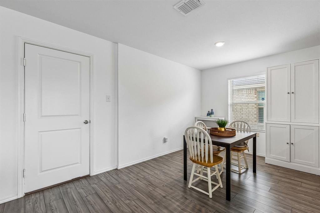 3044 Harper Street Little Elm, TX 75068 - Photo 6 of 24 a view of a dining room with furniture and wooden floor