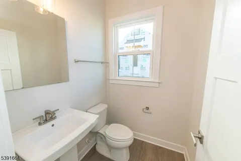 a bathroom with a sink a toilet and mirror