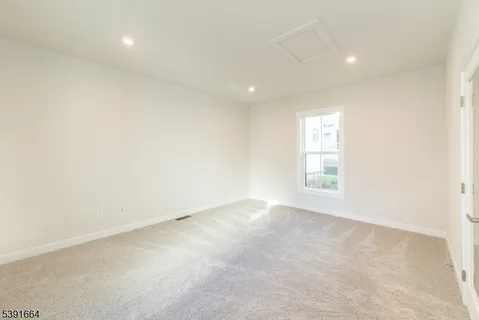 a bedroom with double bed and a couch