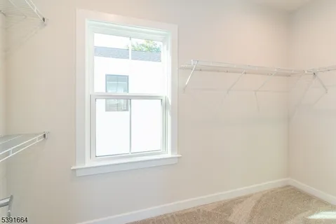a spacious bathroom with a double vanity sink a mirror and a bathtub