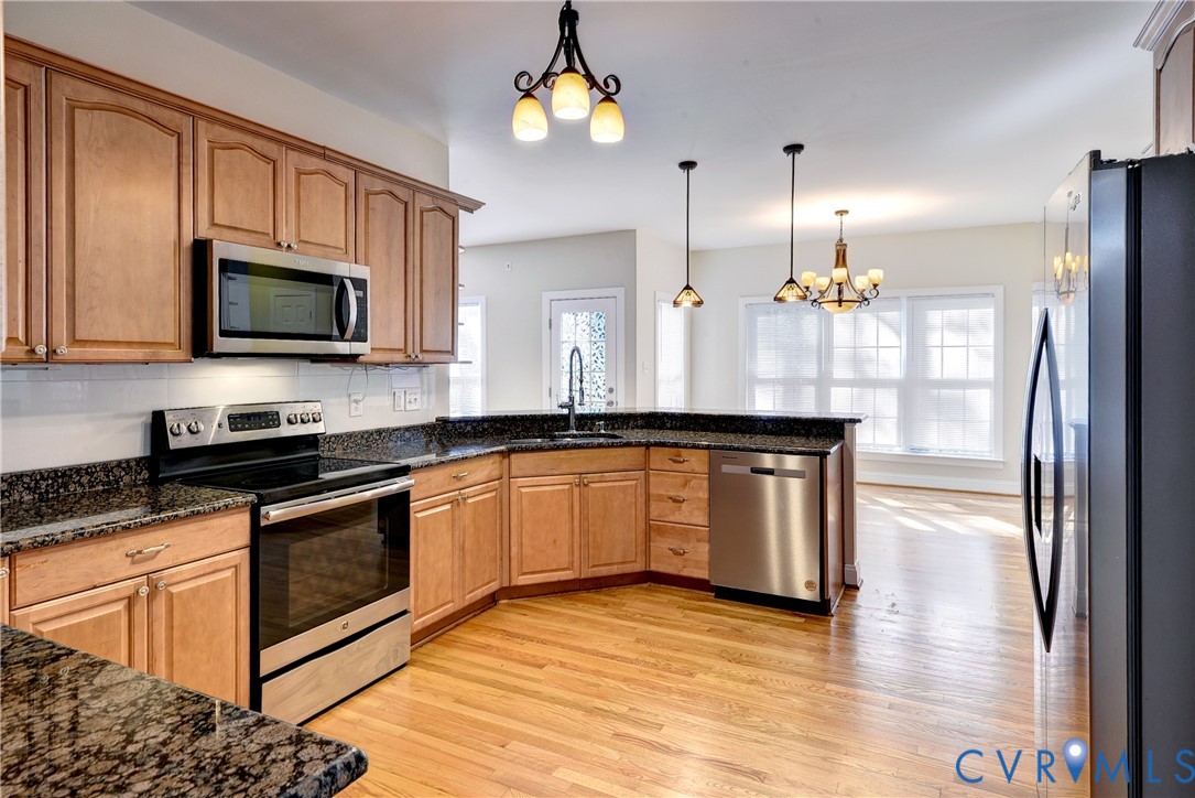 11385 Winding River Road Providence Forge, VA 23140 - Photo 15 of 43 a kitchen with stainless steel appliances granite countertop a stove a sink and a microwave